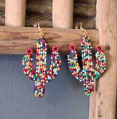 rainbow bead dangle cactus earrings. Casual Dangling Beads Jewelry As Gift, Trendy Colorful Beaded Dangle Earrings, Trendy Colorful Dangle Beaded Earrings, Trendy Multicolor Teardrop Jewelry, Trendy Multicolor Beaded Dangle Earrings, Trendy Colorful Jewelry With Large Beads, Casual Handmade Beaded Dangle Earrings, Trendy Multicolor Drop Earrings, Colorful Large Beads Jewelry For Summer