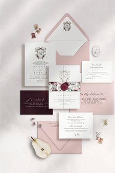 the wedding stationery is laid out on top of each other, including an envelope and two