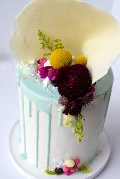 a white cake with flowers and icing on it