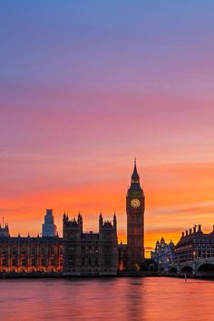 the big ben clock tower towering over the city of london, england at sunset or dawn