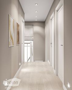 an empty hallway with white walls and wooden floors