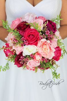 a bridal holding a bouquet of pink and red flowers