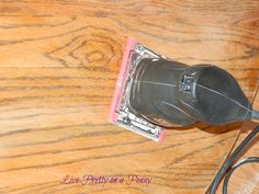 a computer mouse sitting on top of a wooden desk next to a corded phone