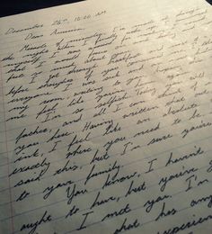 an old handwritten letter is on top of a piece of paper that has been written in cursive writing