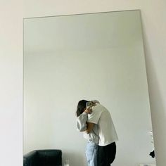 a person taking a selfie in front of a mirror