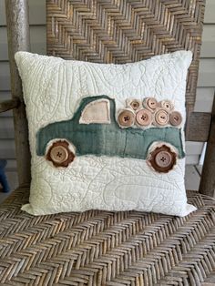 a green truck pillow sitting on top of a wooden chair