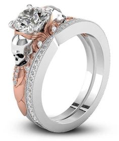 two tone gold and silver wedding ring set with skulls on the sides, featuring a diamond center