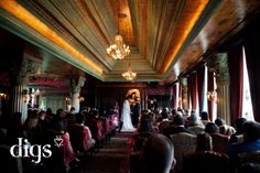 a bride and groom standing at the end of their wedding ceremony in front of an audience