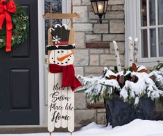 a snowman is standing in front of a house