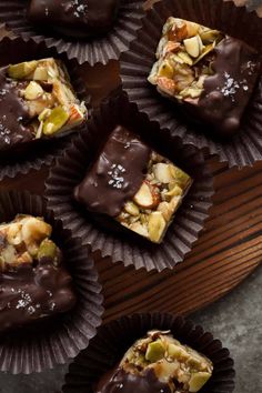 several pieces of chocolate with nuts on top