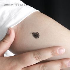 a woman's arm with a small tattoo on the left side of her stomach