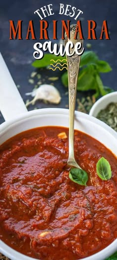 the best marinara sauce is in a white bowl with a spoon and basil leaves on top