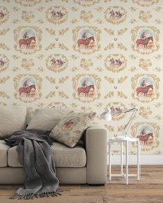 a couch sitting in front of a wallpaper with horses on it and a lamp next to it