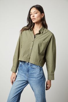 The model is wearing an oversized LUCILLE CROPPED BUTTON-UP SHIRT in olive green by Velvet by Graham & Spencer. Cropped Button Up Shirt, Blouse Size Chart, Velvet Tees, La Fashion, A Button, Short Shirts, Contemporary Fashion, Cotton Poplin, Cotton Shirt