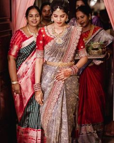 two women in sari standing next to each other