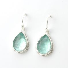 This pair of Roman glass tear shaped earrings are a beautiful aqua color. The patina has been washed away and show the beauty of the glass. Handmade with sterling silver, these post earrings are 1 1/4 inches long and 3/8 inch wide and come in a gift box. Each piece from our Roman glass collection comes with a certificate of authenticity and reflects that these fragments are over 2,000 years old. Style Number: 1784 Metal: 925 Sterling Silver Genuine Ancient Roman Glass Dimensions: 1 1/4 inches long and 3/8 inch wide Handmade in Israel Care: A polishing cloth is all you will need to care for the sterling silver. Ancient Roman Glass, Roman Glass, Teardrop Dangle Earrings, Aqua Color, Ancient Romans, Sterling Earrings, Glass Collection, Post Earrings, Sterling Silver Earrings