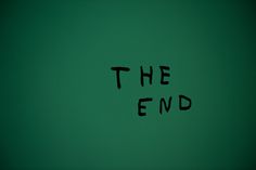 the end written in black ink on a green wall