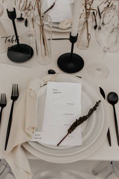 the table is set with black and white place settings