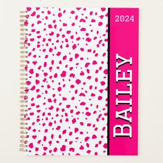 a pink and white spiral notebook with the words battery printed on it