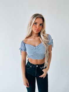 DETAILS: Our Morrilyn Crop Top is an off the shoulder crop top is loaded full of details. This top features a padded bust, smocked bodice, and off the shoulder neckline. The sleeves on this top feature elastic to give the top a more secure fit. This top has a lot of stretch throughtout if in between sizes we recommend sizing up. CONTENT & CARE: SELF: 100% Polyester SIZE & FIT: Model is 5'6" The model is wearing a size medium Fits true to size The Fabric has stretch Trendy Short Sleeve Crop Top With Smocked Bodice, Trendy Ruched Cropped Smocked Top, Trendy Smocked Crop Top, Cropped Tube Top With Smocked Bodice, Fitted Bandeau Crop Top With Smocked Bodice, Fitted Smocked Bandeau Crop Top, Spring Smocked Bodice Bandeau Crop Top, Fitted Smocked Bodice Bandeau Crop Top, Spring Crop Top With Smocked Bodice And Short Sleeves