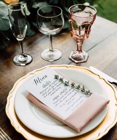 a place setting with wine glasses and napkins