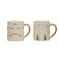 two white mugs with gold handles and designs on the sides, one has a house