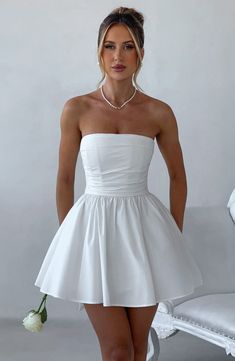 THE dress of the season has landed and you're going to be obsessed. Meet Katrina, our dreamy ivory mini with a pretty, voluminous skirt and waist cinching bodice. Fastening with a zip to the back, an oversized bow completes the look for perfect feminine drama. Formal Fits, Homecoming Dresses Corset, Second Dress, Bowknot Dress, Voluminous Skirt, Looks Party, Maxi Dress Sale, Popular Dresses, Sparkle Dress