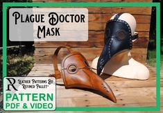 two leather masks sitting on top of a wooden table next to a sign that says plague doctor mask