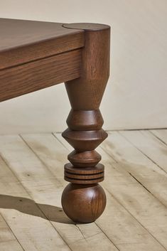 a close up of a wooden bench on the floor