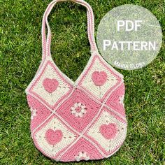 a pink and white crocheted bag sitting on top of grass with the words free pattern