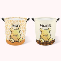 two buckets with winnie the pooh designs on them, one is white and the other is yellow