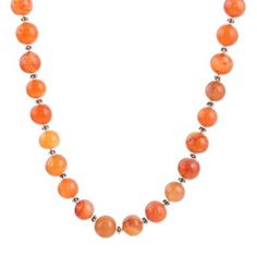 This fiery orange necklace designed by India's Shawn Martin will make you feel unstoppable whether at the office or on a date. The artisan hand threads a row of smooth carnelian orbs to create the necklace alternating each gemstone with a tiny sterling silver bead. Orange Carnelian Polished Beads Necklace, Orange Gemstone Beads Round Necklaces, Orange Round Gemstone Bead Necklaces, Orange Gemstone Beads Necklace, Orange Round Gemstone Beads Necklace, Orange Carnelian Single Strand Beaded Necklace, Single Strand Orange Carnelian Beaded Necklace, Orange Necklace, Silver Bead Necklace