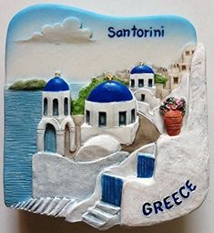 a ceramic tile with the name and image of a greek town on it's side