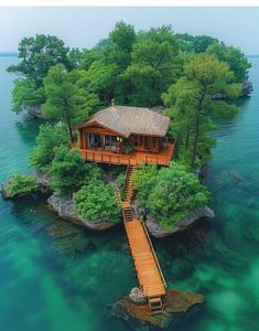 an island with a house on it surrounded by trees