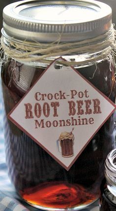 a mason jar filled with root - pot beer sits on a table