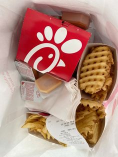 a waffle sandwich in a red box with white writing on it and a dog paw sticker