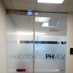 a welcome to phmg sign in an office