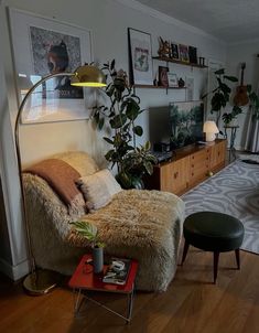 a living room filled with furniture and lots of plants