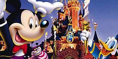 mickey mouse and friends in front of a castle at night with fireworks coming from it