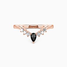 a rose gold ring with black and white diamonds