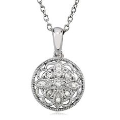 This vintage-inspired sterling silver design has an old fashioned elegance that never goes out of style. The 15mm circle blossom features an open motif infused with nine white diamonds and finished with milgrain detailing. It includes a sterling silver cable chain finished with a spring ring clasp. Each round cut diamond is I2 in clarity and G-H in color. Total diamond weight is .05 of a carat. Classic Diamond White Flower Shaped Jewelry, Classic Silver Necklace With Flower Shape, Timeless Silver Flower Pendant Jewelry, Silver Flower Pendant Jewelry With Single Cut Diamonds, Classic Medallion Jewelry With Diamond Accents, Heirloom Silver Jewelry With Pave Setting, Classic Single Cut Diamond Flower Pendant, Classic Single Cut Diamond Flower Pendant Jewelry, Classic Flower Pendant Jewelry With Single Cut Diamonds