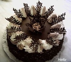 a chocolate cake with white frosting and decorative decorations