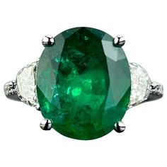 A beautiful 7.12 carat oval shaped natural Zambian Emerald three-stone engagement ring, with 0.62 carat half-moon diamonds and 0.13 carat round diamonds on the band. The center stone is of top quality, with a stunning vivid green color and is transparent with great luster. The gemstones are set in solid 18K White Gold, and is sized at US 7 (can be resized) We provide free shipping, and accept returns. Please feel free to message us for more information. Three Stone Engagement Rings Emerald, Three Stone Engagement Ring, Zambian Emerald, Modern Engagement Rings, Stone Engagement Ring, Three Stone Engagement, Three Stone Engagement Rings, Stone Engagement Rings, Stone Engagement