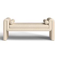 an upholstered bench with two legs and three balls on the back, sitting in front of a white background