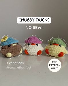 three small crocheted birds sitting next to each other