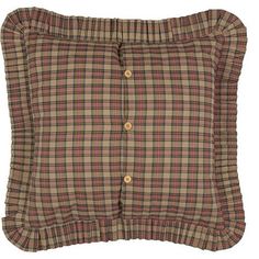 a plaid pillow with ruffled edges and buttons on the front, sitting on a white background