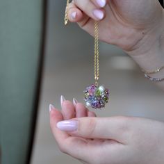 Handmade Large Stone Pendant meticulously crafted to exude elegance and sophistication. This stunning pendant features a harmonious blend of gemstones, including agate, peridot, and strawberry quartz, complemented by freshwater pearls and delicate Japanese seed beads and glass beads, all intricately woven to create a mesmerizing design. Each pendant is uniquely handcrafted, ensuring its one-of-a-kind charm. The striking green hues of the gemstones add a touch of nature-inspired beauty, making it a perfect accessory for any occasion. Paired with a high-quality gold plated chain, this pendant effortlessly radiates femininity and grace. The ball pendant design adds a contemporary flair, while the round pendant shape enhances its timeless appeal. Whether worn as a standalone statement piece or Green Pendant Necklace, Feminine Jewelry, Green Pendant, Green Pendants, Large Stone, Green Hues, Pendant With Chain, Ball Pendant, Strawberry Quartz