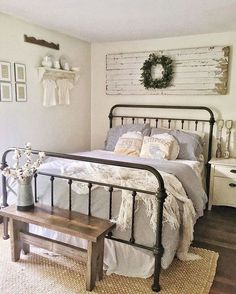 a bed room with a neatly made bed and a wooden bench in front of it