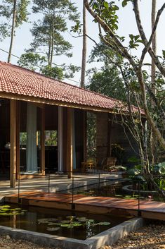 a house that is surrounded by trees and water