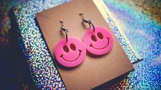 Introducing these adorable laser-cut Smiley earrings, designed to add a pop of cheer to your everyday style! Crafted from vibrant pink acrylic and assembled with hypoallergenic hooks. These earrings are as comfortable as they are eye-catching. CARE INSTRUCTIONS: ★ Please note that although these earrings are water-resistant, it is best to avoid submerging them in water to ensure their longevity.  ★ Additionally, when it comes to cleaning the acrylic, we recommend avoiding alcohol-based solutions Pink Hypoallergenic Plastic Earrings, Handmade Pink Plastic Earrings, Everyday Pink Pierced Earrings, Trendy Pink Plastic Jewelry, Fun Neon Earrings For Gifts, Playful Pink Plastic Earrings, Fun Pink Earrings For Pierced Ears, Nickel-free Pink Novelty Earrings, Novelty Pink Nickel-free Earrings